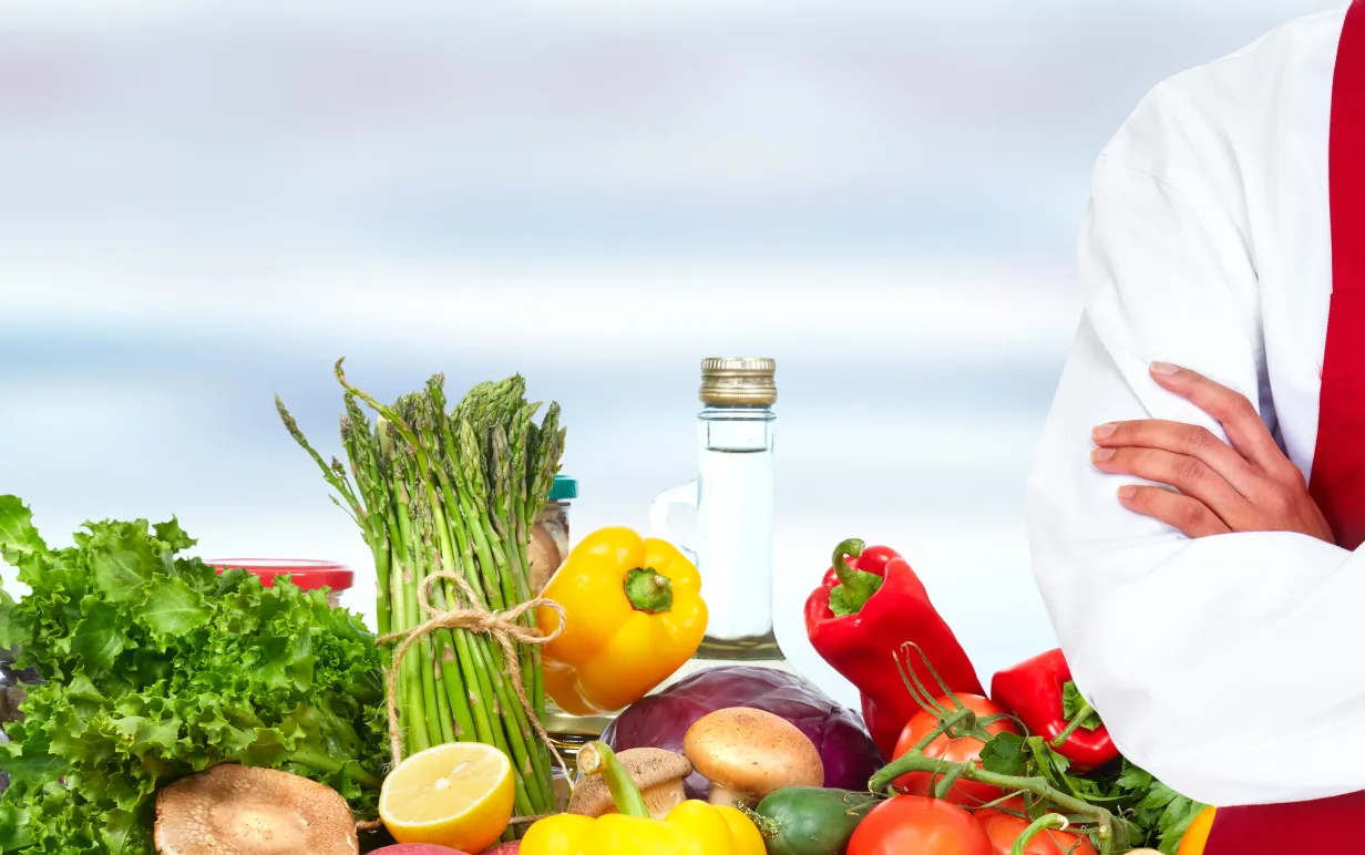 Bild på grönsaker och kock med korsade armar