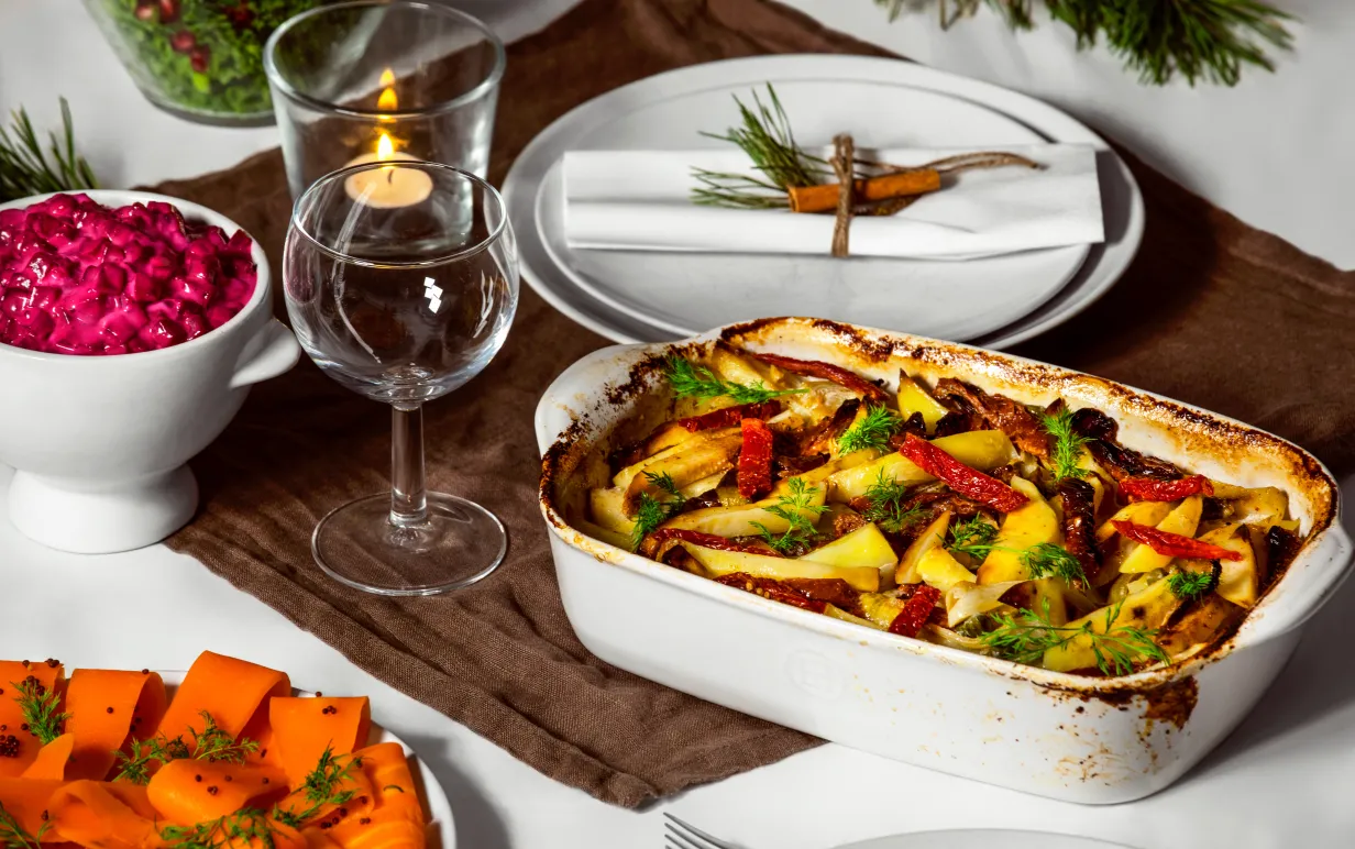 Janssons frestelse i en vit ugnsform på ett dukat bord.