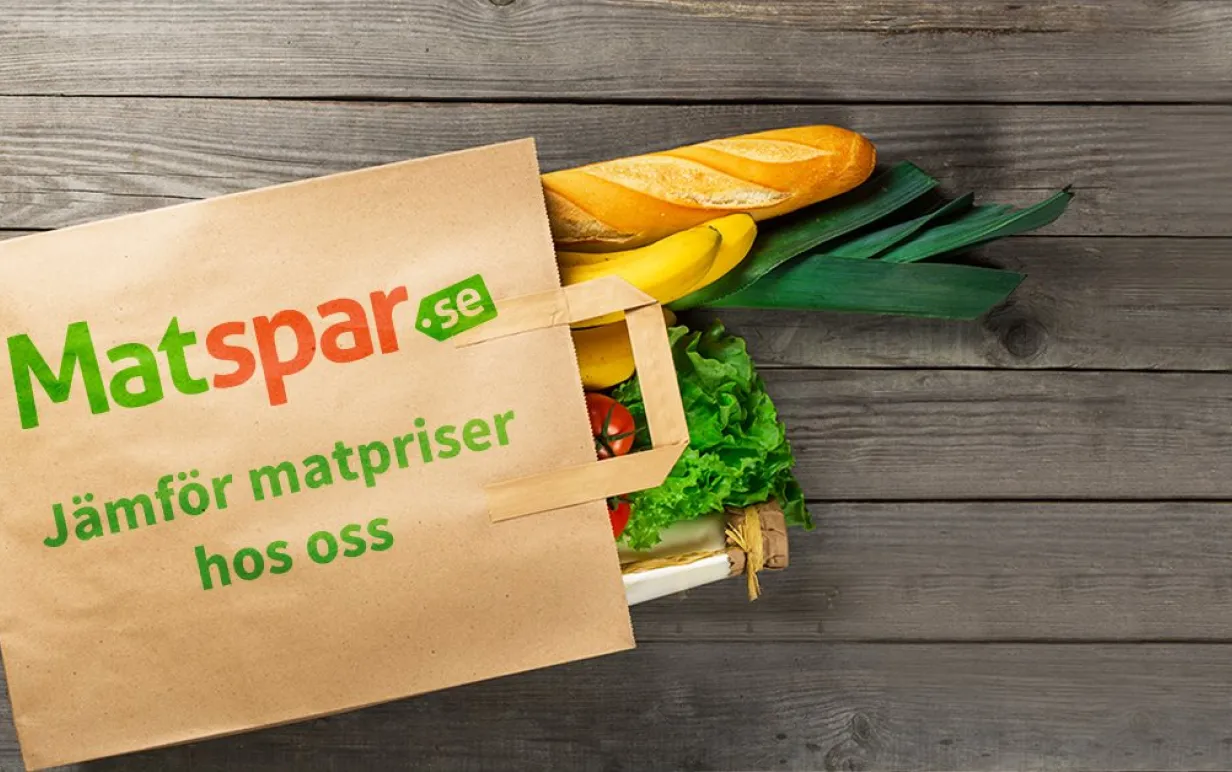 Liggande papperskasse där en baguette och grönsaker sticker ut