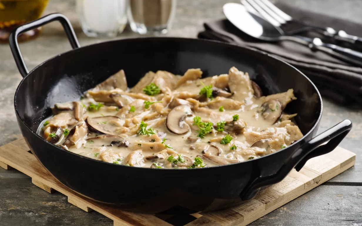 Vegan soy meat stripes and mushrooms in creamy sauce