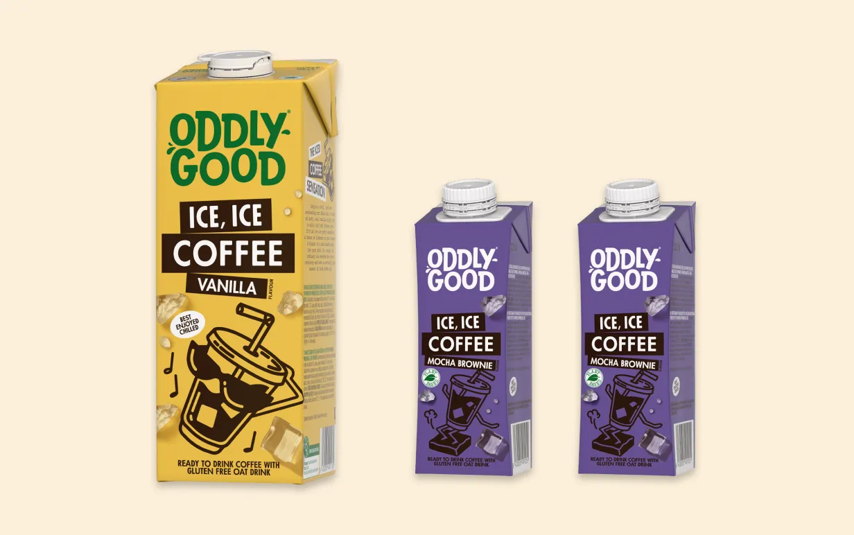 Tre förpackningar växtbaserade drycker uppradade mor en ljusgul bakgrund