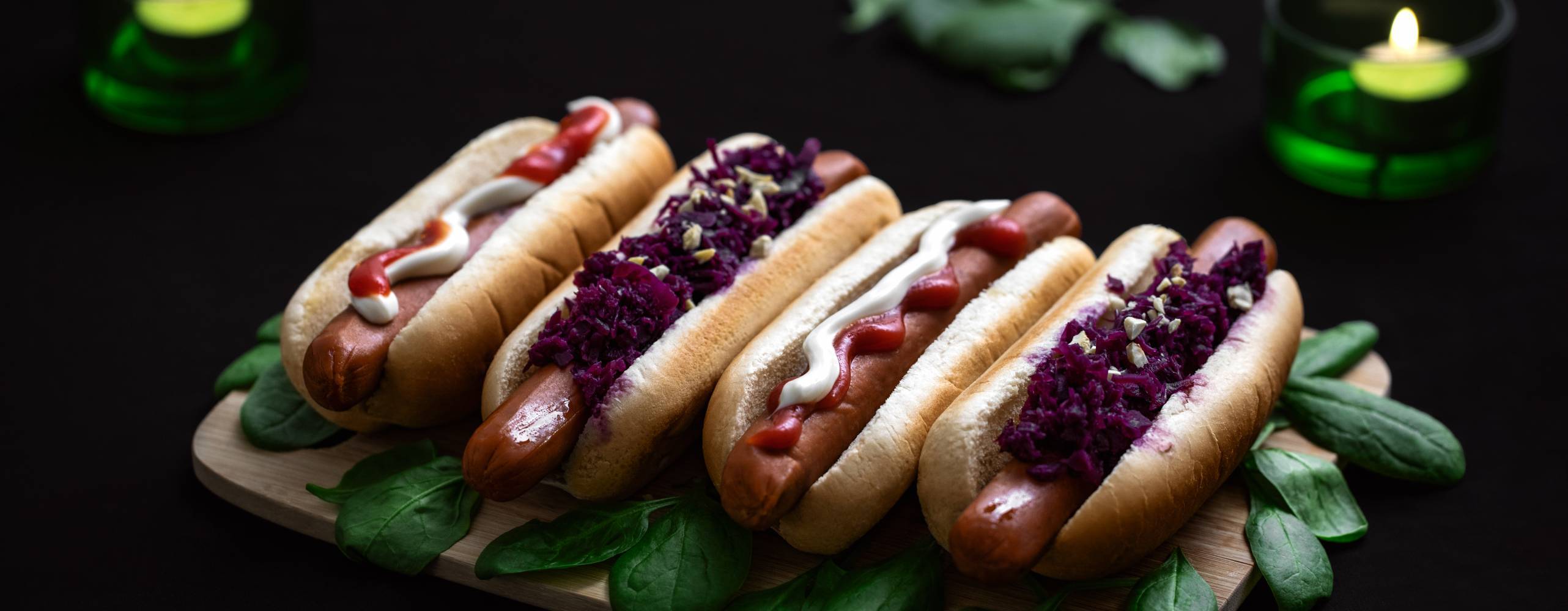 Fyra veganska korv med intill varandra på en bräda