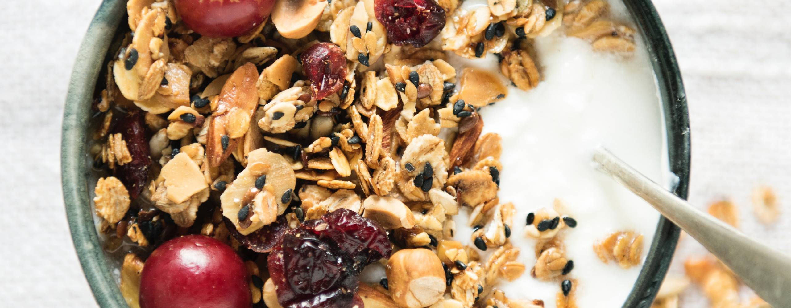 Vit dryck i ett glas med med havre och nötter