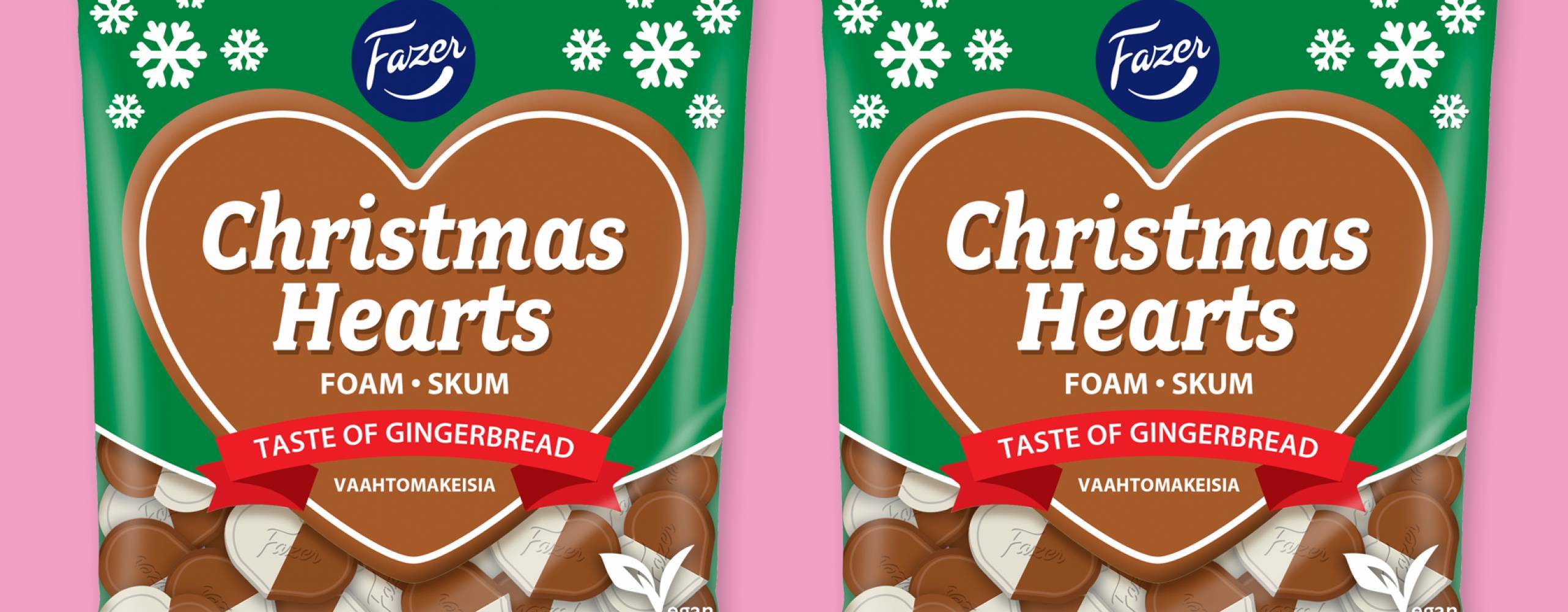 Christmas Hearts från Fazer, två påsar bredvid varandra mot rosa bakgrund.