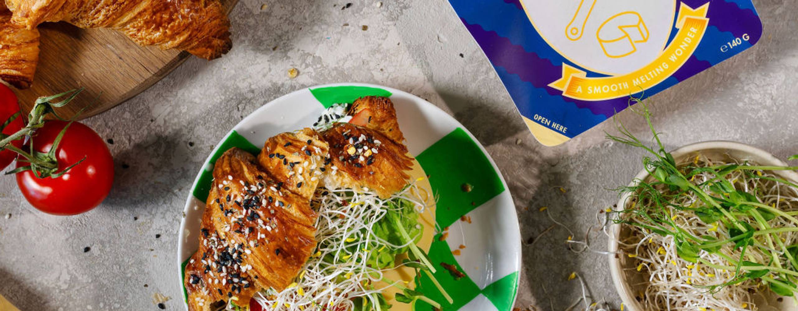 Ett frukostbord med gifflar, grönsaker och växtbaserad ost