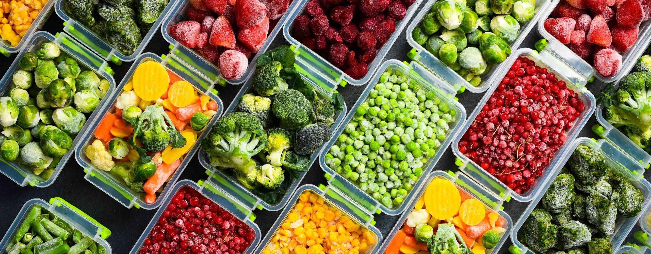 Frysta grönsaker uppradade i matlådor